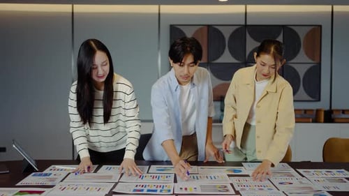 Workers Study Charts at Corporate Meeting