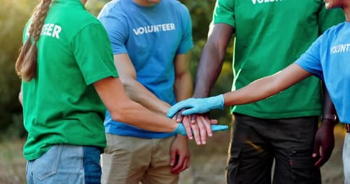 Group of Volunteers Joining Hands in Unity