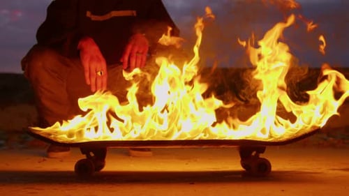 Burning Skateboard on Pavement at Night