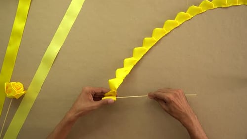 Hands Crafting Yellow Fabric Flower