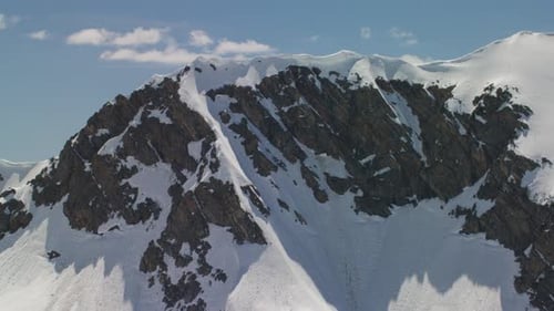 The Snowcapped Peaks and Sheer Cliffs of the Grand Teton Mountains In