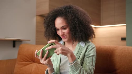 Woman Loosing Video Game Using Mobile Phone