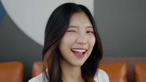 Young Woman Smiling and Winking at the Camera
