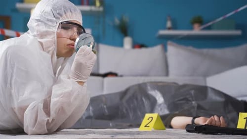 Investigator Examines Bullet at Indoor Crime Scene