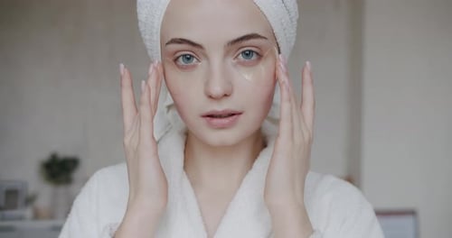 Woman Applies Cosmetic Patches for Eye Treatment