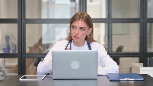 Female Doctor Talking with Patient Online in Clinic