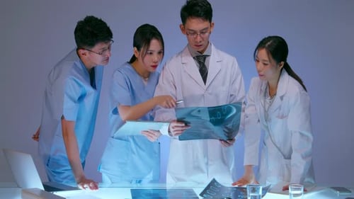 Medical Team Analyzing X-Ray in Futuristic Facility
