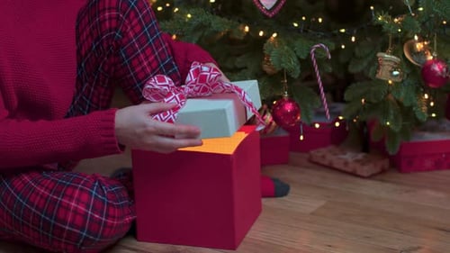Woman Opens Christmas Gift with Glowing Surprise