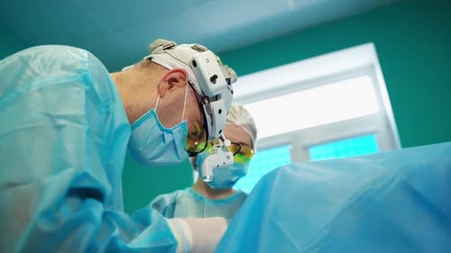 Surgeons Performing Operation in Brightly Lit Operating Room