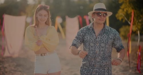 Happy Young Couple Dancing at Beach