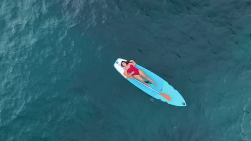 Aerial View Paddleboarding in a CrystalClear Mediterranean Lagoon Surrounded By Scenic Beauty