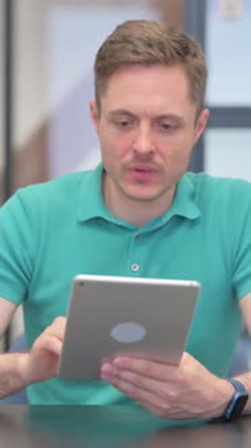 Stressed Man Using Tablet in Office