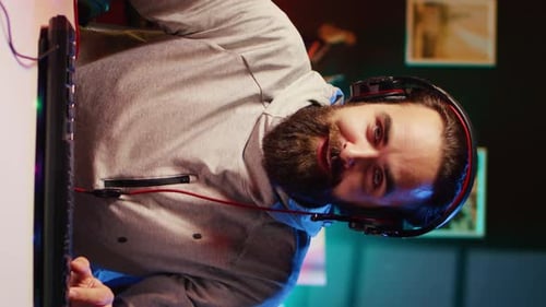 Male Gamer Playing at Computer at Night