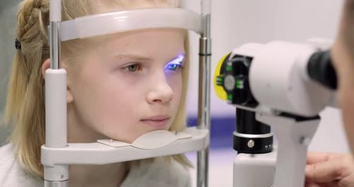 Doctor and Young Patient in Eye Clinic Girl Undergoing an Eye Test with Professional Optometrist