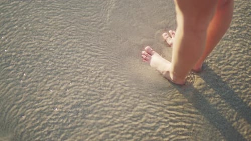 Woman, beach and relax with feet in water, sand or waves on vacation, summer holiday or outdoor