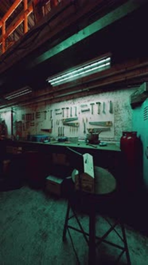 Room Filled With Tables and Chairs in Old Auto Repair Shop