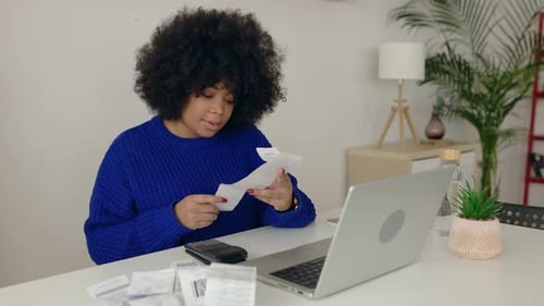 Young Latin American Woman Managing Budget and Expenses at Home