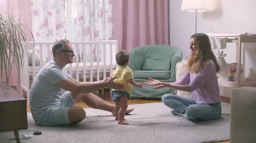 Family Celebrates Baby's First Steps in Nursery