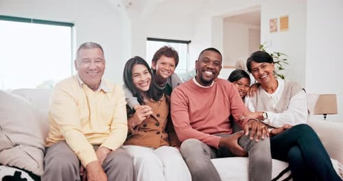 Cheerful Family Smiling Together on Comfortable Sofa