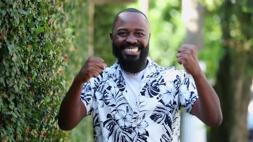 Happy Man Celebrates Success Outdoors in Nature