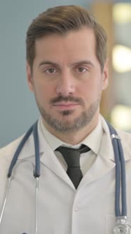 Portrait of Serious Male Doctor in Clinic, vertical video
