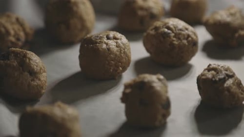 Chocolate Chip Cookie Dough On Tray Ready For Baking. - tilt down close up
