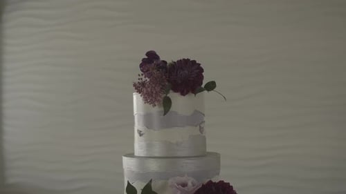 Elegant Three-Tiered Cake with Purple Flowers
