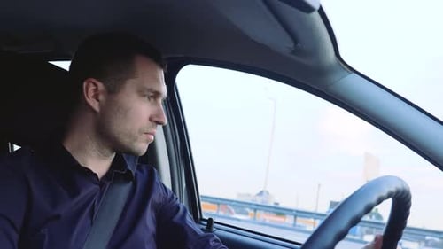Man Drives Car on City Commute