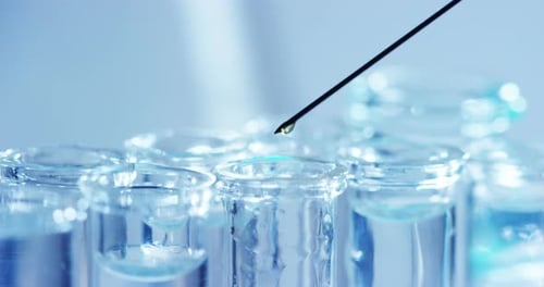 Liquid Drop into Scientific Laboratory Test Tubes