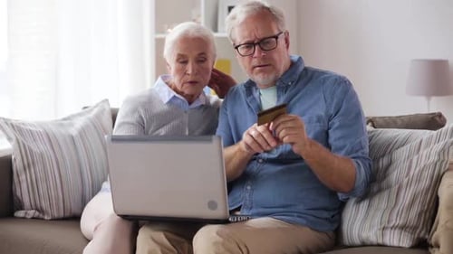 Senior Couple Shopping Online at Home With Laptop