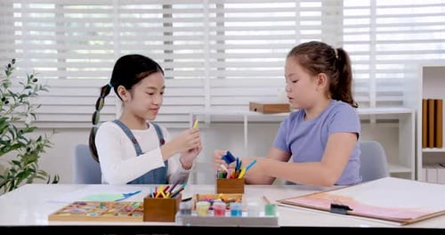 Two Children Doing Crafts Together at Home