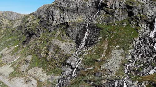 Waterfall In Mountains. Norwegian Route Sognefjellet