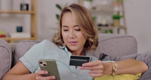 Woman, phone and credit card on sofa for ecommerce, online shopping or internet banking at home