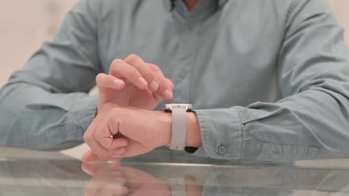 Close up of Mature Adult Man Using Smartwatch