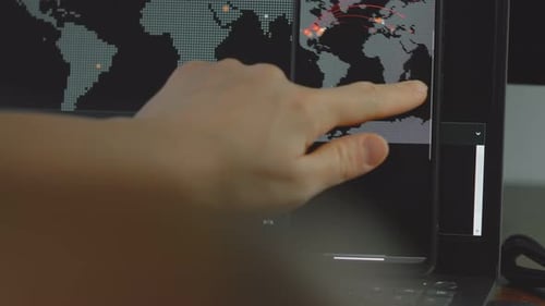 Hand Interacting With Digital World Map Screens