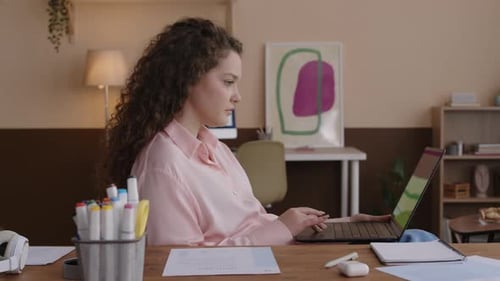Young Adult Woman Working on Laptop with Green Screen