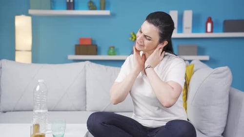 Woman with Neck Pain Rubbing Her Neck