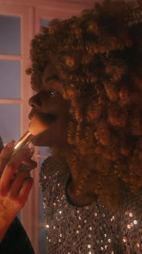 Vertical of Make-Up Artist Applying Face Powder to Smiling Female Star