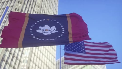 Patriotic Mississippi and USA Flags Waving Against Blue Sky