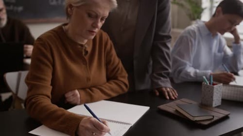 Teacher Helping Student in Classroom Setting