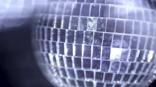 Sparkling Disco Ball Reflecting Light in a Dark Space