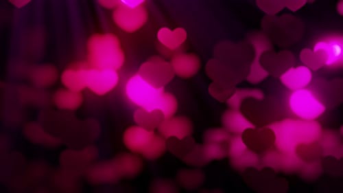 Seamless loop background with valentines hearts flying against light on black 4k