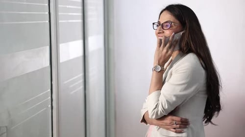Professional Woman Talking On Phone In Office