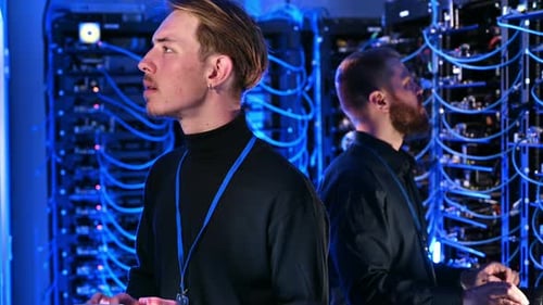 Engineers Working in Data Center With Servers