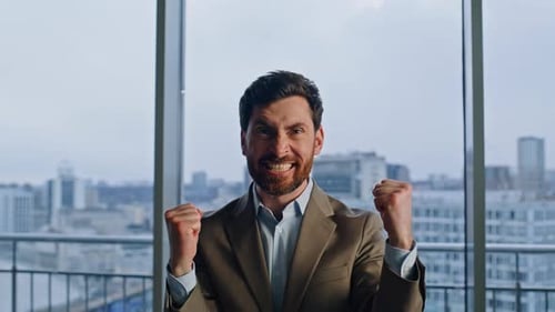 Business Owner Rejoicing Achievement at City View Window Closeup Man Winning