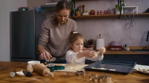 Woman and Girl Baking Cookies in Kitchen
