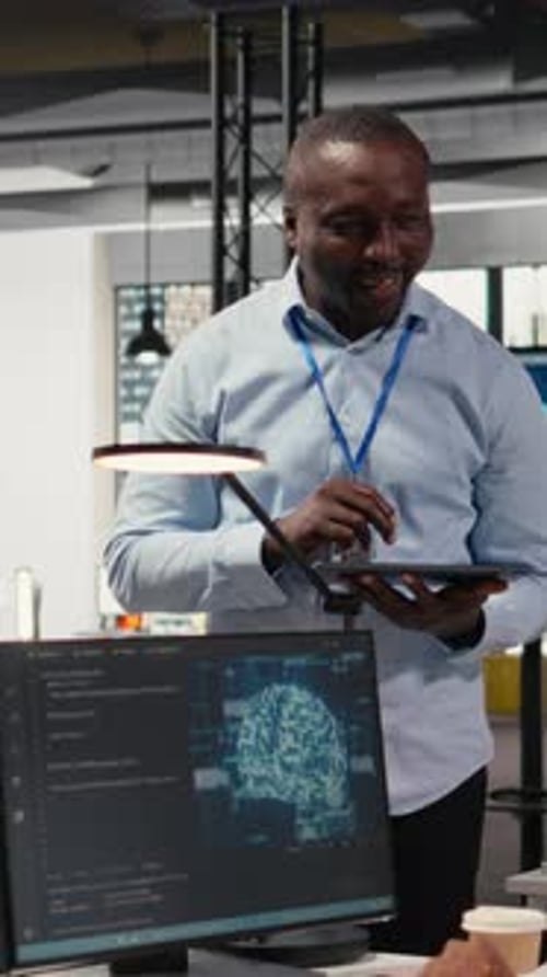 Vertical Video Smiling IT Staff Members in Office Using AI to Optimize Company Systems