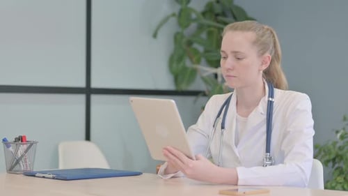 Female Doctor using Tablet in Clinic