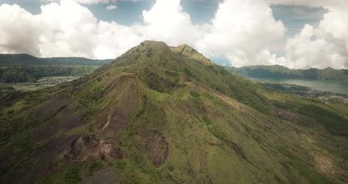 Mount Batur crater and surrounding landscape, active volcano on Bali island, Indonesia. Aerial forwa