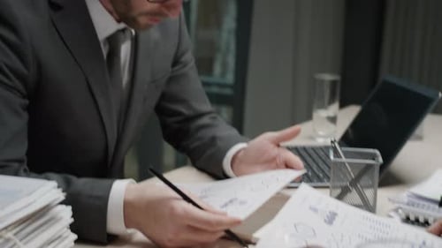 Businessmen Discussing Data in Modern Office